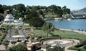 A view of the Aquatic park Historic District including the Maritime Museum, lawns, beach and cove.