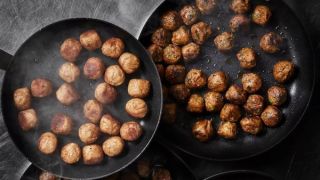 Meatballs cooking in pans