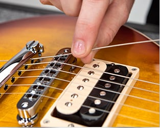 musical instrument repair shop orange Guitar Center Repairs