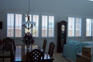 These elegant yet functional shutters complement the room's beautiful decor, maximizing both the light and the view.