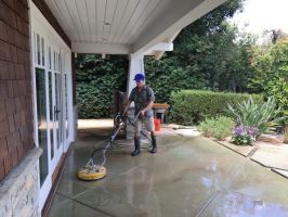 Man cleaning concrete floor