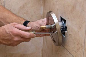 Plumber removes bathtub hardware
