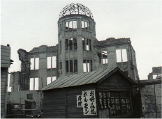 An okonomiyaki restaurant can be seen in front of the famous Genbaku Dome.